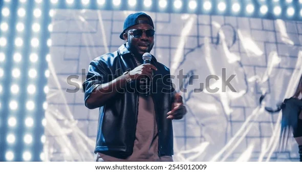 rap-artist-performing-on-vibrant-600w-2545012009 (1)