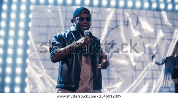 rap-artist-performing-on-vibrant-600w-2545012009 (1)